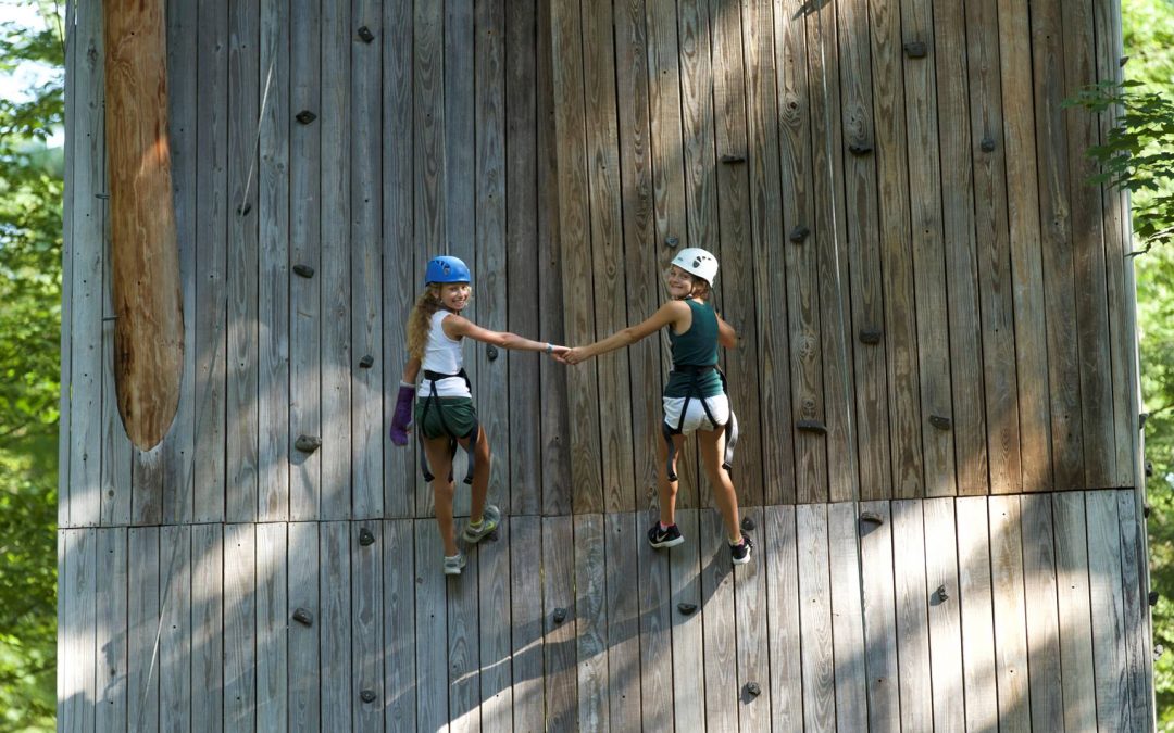 campers on climbing wall